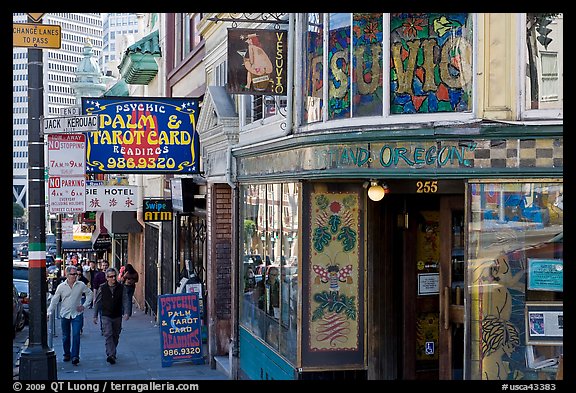 Sidewalk with Vesuvio Cafe, Jack Kerouac street sign, Columbus Tower, and Transamerica Pyramid, North Beach. San Francisco, California, USA