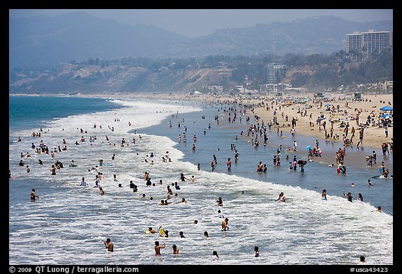 Many people bathing in surf at Santa Monica Beach. Santa Monica, Los Angeles, California, USA