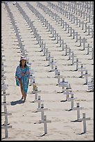 Girl wrapped in towel walking amongst crosses on beach. Santa Monica, Los Angeles, California, USA ( color)