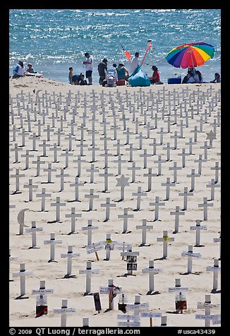 War memorial and families at edge of water on beach. Santa Monica, Los Angeles, California, USA (color)