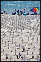 War memorial and families at edge of water on beach. Santa Monica, Los Angeles, California, USA