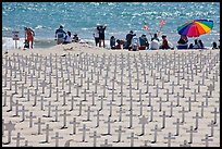 Wooden crosses, stars of David, and beachgoers. Santa Monica, Los Angeles, California, USA (color)