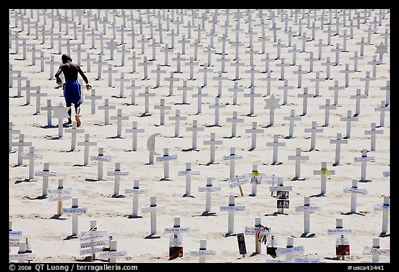 Boy in beachwear walking amongst crosses. Santa Monica, Los Angeles, California, USA