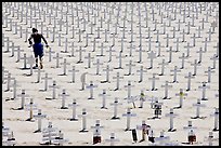 Boy in beachwear walking amongst crosses. Santa Monica, Los Angeles, California, USA ( color)