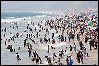 Crowds of beachgoers in water. Santa Monica, Los Angeles, California, USA