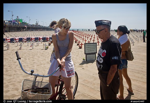 Veteran for peace conversing with woman on bicycle. Santa Monica, Los Angeles, California, USA