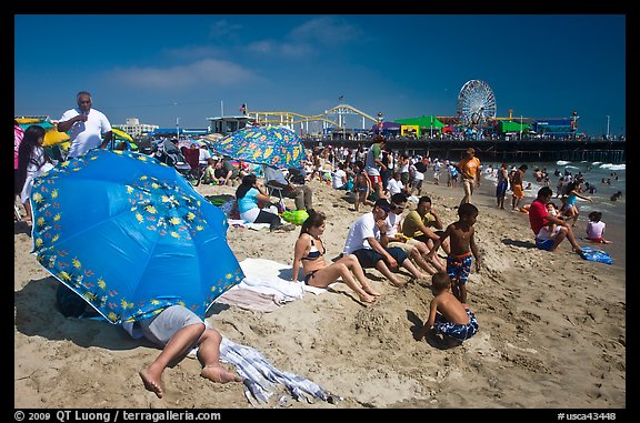 Beach unbrellas and Santa Monica Pier. Santa Monica, Los Angeles, California, USA