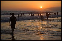 Ocean bathers at sunset, Santa Monica Beach. Santa Monica, Los Angeles, California, USA (color)