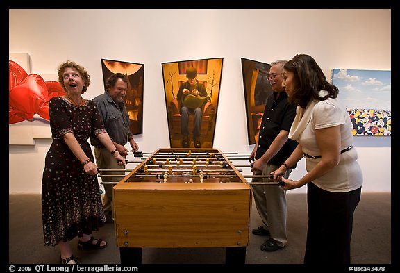 Playing soccer table game in art gallery, Bergamot Station. Santa Monica, Los Angeles, California, USA (color)