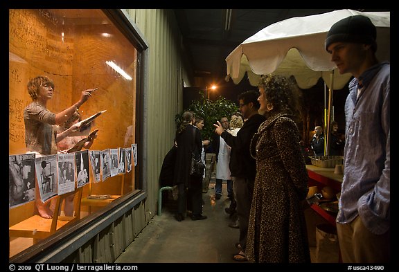 People watch performance artists in window, Bergamot Station. Santa Monica, Los Angeles, California, USA
