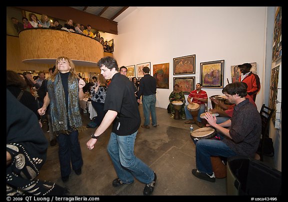 Guest dance to drums on art gallery opening night, Bergamot Station. Santa Monica, Los Angeles, California, USA (color)