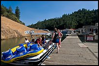 Deck with family preparing a boat, Shasta Lake. California, USA