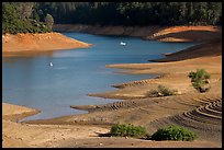 Red earth around an arm of Shasta Lake. California, USA