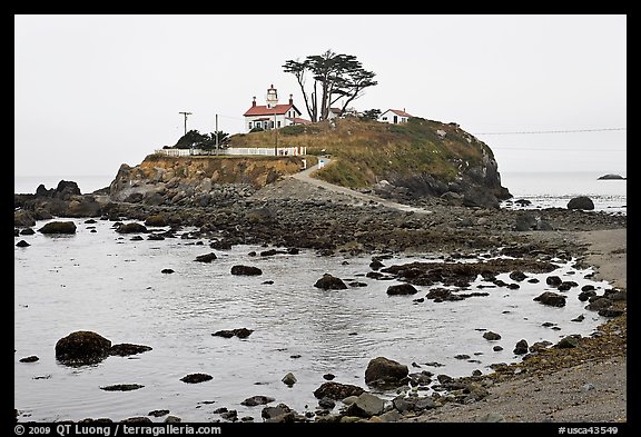 Rocky mound and lighthouse, Crescent City. California, USA