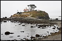 Rocky mound and lighthouse, Crescent City. California, USA (color)