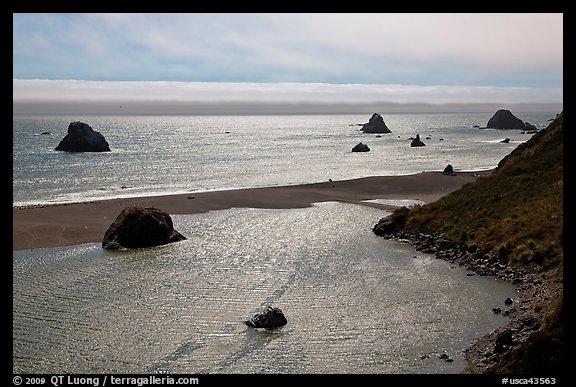 Shimmering ocean and river separated by sliver of sand, Jenner. Sonoma Coast, California, USA