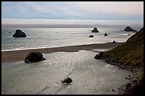 Shimmering ocean and river separated by sliver of sand, Jenner. Sonoma Coast, California, USA