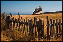 Fences, summer grass and chapel towers, Fort Ross. Sonoma Coast, California, USA