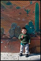 Boy and mural, Mission District. San Francisco, California, USA (color)