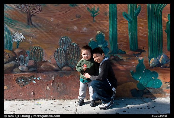 Boys and mural, Mission District. San Francisco, California, USA (color)