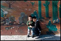 Boys and mural, Mission District. San Francisco, California, USA