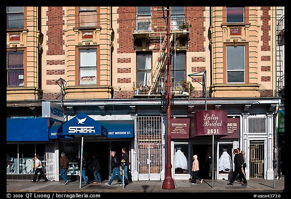 People walking on sidewalk, Mission Street, Mission District. San Francisco, California, USA (color)