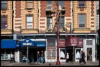 People walking on sidewalk, Mission Street, Mission District. San Francisco, California, USA