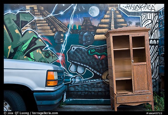 Car, mural, and discarded furniture, Mission District. San Francisco, California, USA (color)