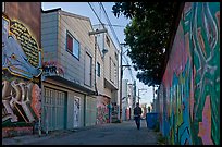 Man walking in alley, Mission District. San Francisco, California, USA (color)