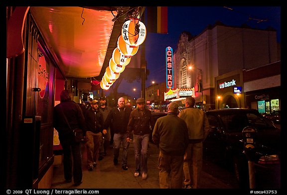 Men walking on sidewalk, Castro street at night. San Francisco, California, USA (color)