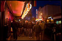 Men walking on sidewalk, Castro street at night. San Francisco, California, USA (color)
