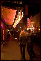 Couple on Castro street at night. San Francisco, California, USA