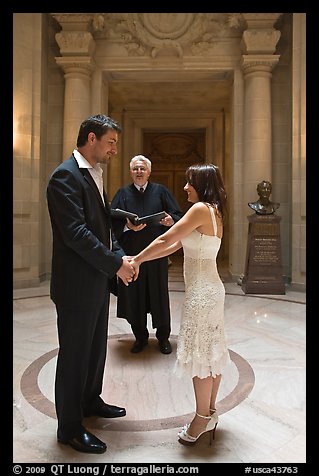 Bride, groom, and wedding officant, City Hall. San Francisco, California, USA