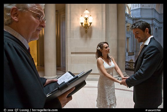 Officiant and couple getting married, City Hall. San Francisco, California, USA (color)