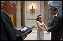 Officiant and couple getting married, City Hall. San Francisco, California, USA (color)