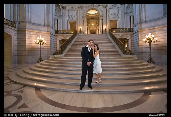 Just married couple at the base of the grand staircase, City Hall. San Francisco, California, USA (color)