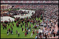 Audience and graduates mingling in stadium after commencement. Stanford University, California, USA (color)