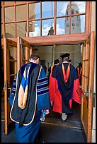 Professors in academic regalia walk into door with Hoover tower reflected. Stanford University, California, USA ( color)