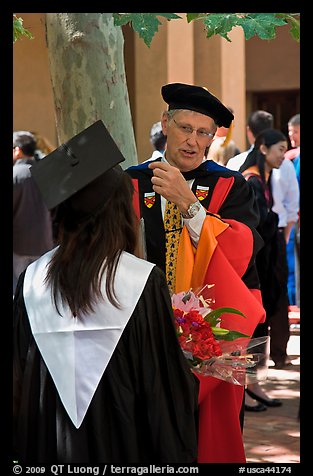 Faculty in academic dress talks with student. Stanford University, California, USA