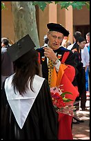 Faculty in academic dress talks with student. Stanford University, California, USA (color)