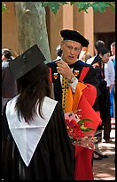 Faculty in academic dress talks with student. Stanford University, California, USA (color)