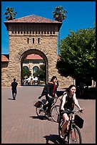 Students riding bicycles through Main Quad. Stanford University, California, USA (color)