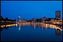 Oakland skyline reflected in Lake Meritt, twilight. Oakland, California, USA (color)