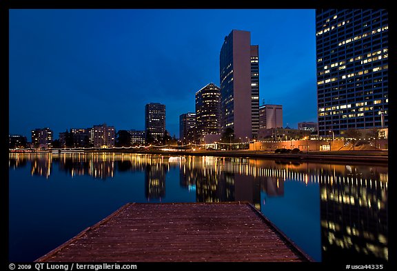 High-rise buildings, deck, and Lake Meritt, dusk. Oakland, California, USA