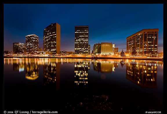 High-rise buildings and Oakland Cathedral reflected in Lake Meritt at night. Oakland, California, USA (color)