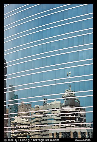 Federal building reflected in glass facade. Oakland, California, USA