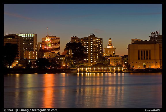 Oakland skyline reflected in Lake Merritt at night. Oakland, California, USA