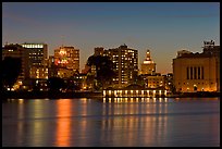 Oakland skyline reflected in Lake Merritt at night. Oakland, California, USA