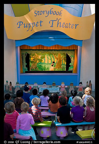 Children look at Snow white puppet show, Fairyland. Oakland, California, USA (color)