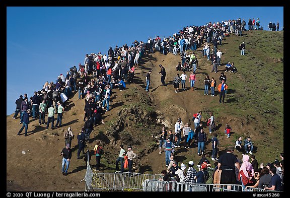 Crowds scrambling on hill during mavericks competition. Half Moon Bay, California, USA (color)